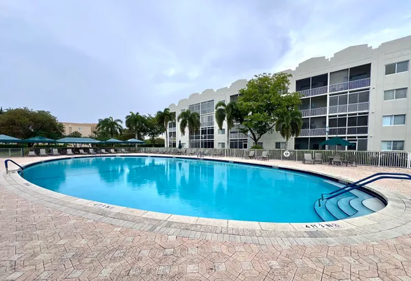 a swimming pool with outdoor seating and yard