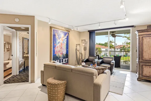 a living room with furniture and large windows