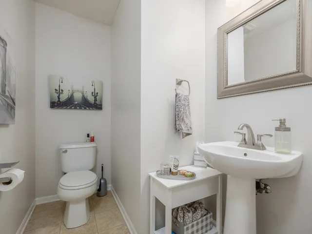 a bathroom with a sink toilet and a mirror