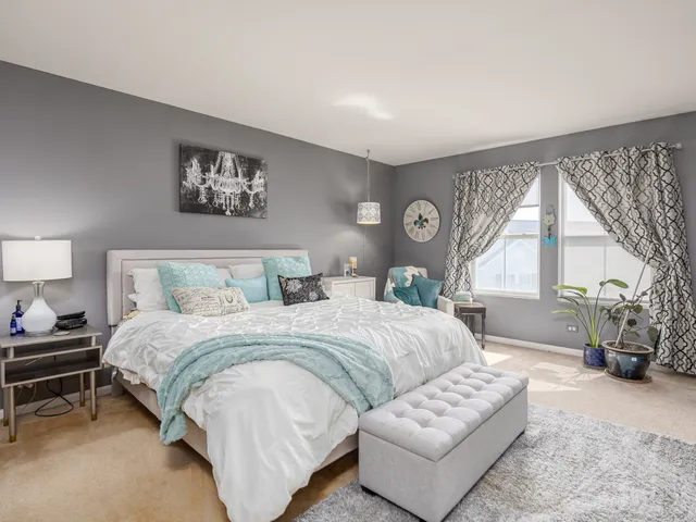 a bedroom with a large bed and a couch