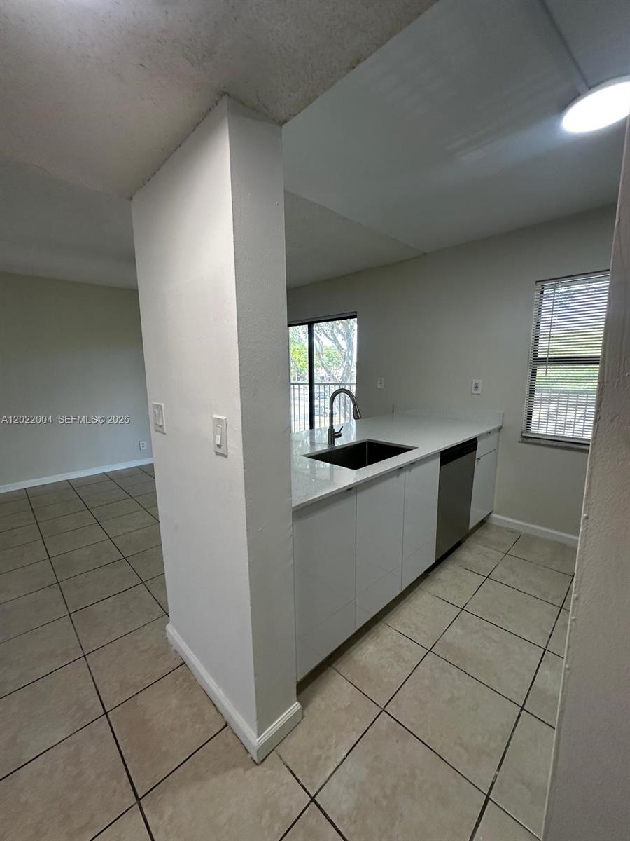 3400 Foxcroft Road, Unit 301 Miramar, FL 33025 - Photo 24 of 72 a kitchen with granite countertop a refrigerator and a stove top oven