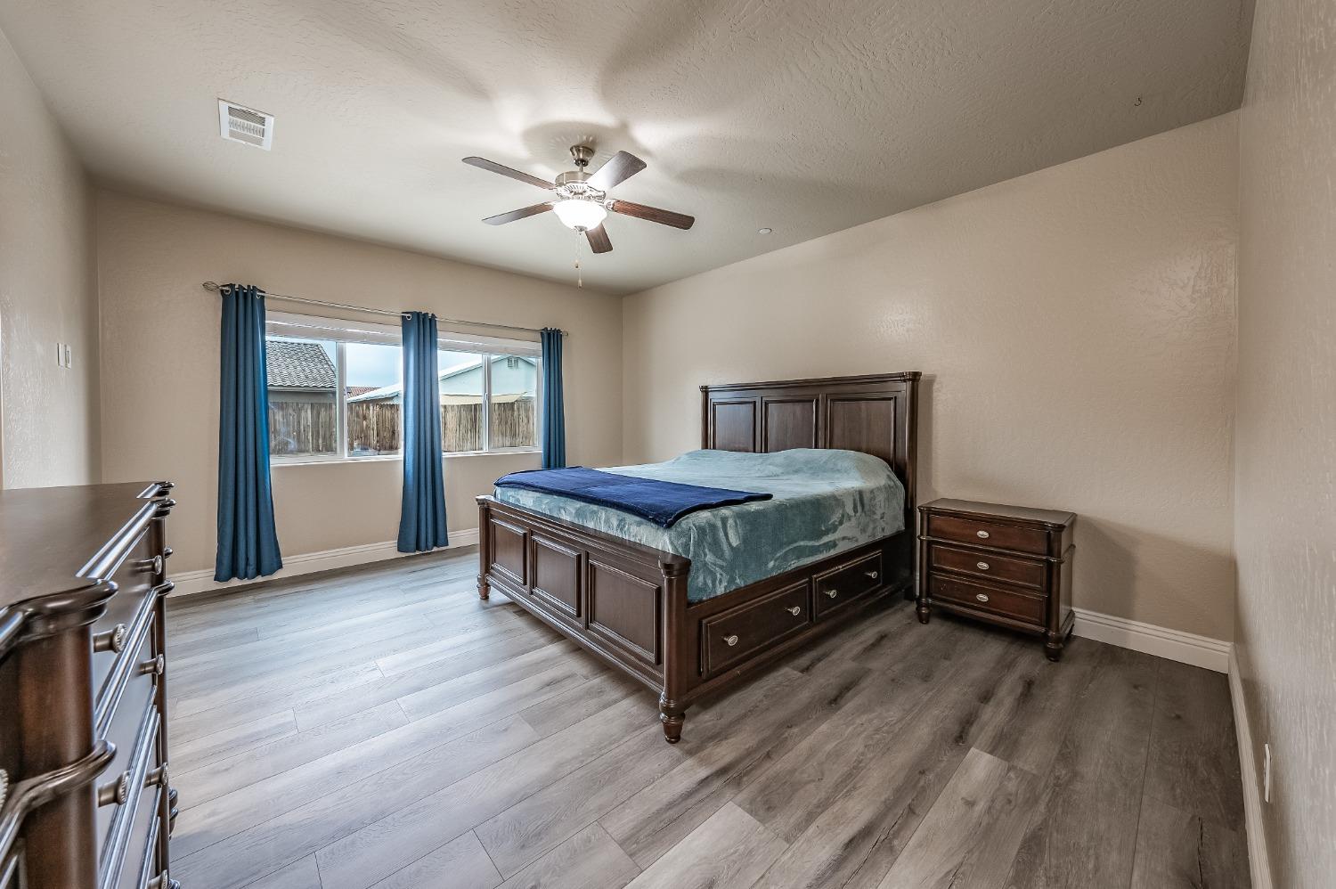 742 Strada Street Lemoore, CA 93245 - Photo 19 of 40 a bedroom with a bed and a window