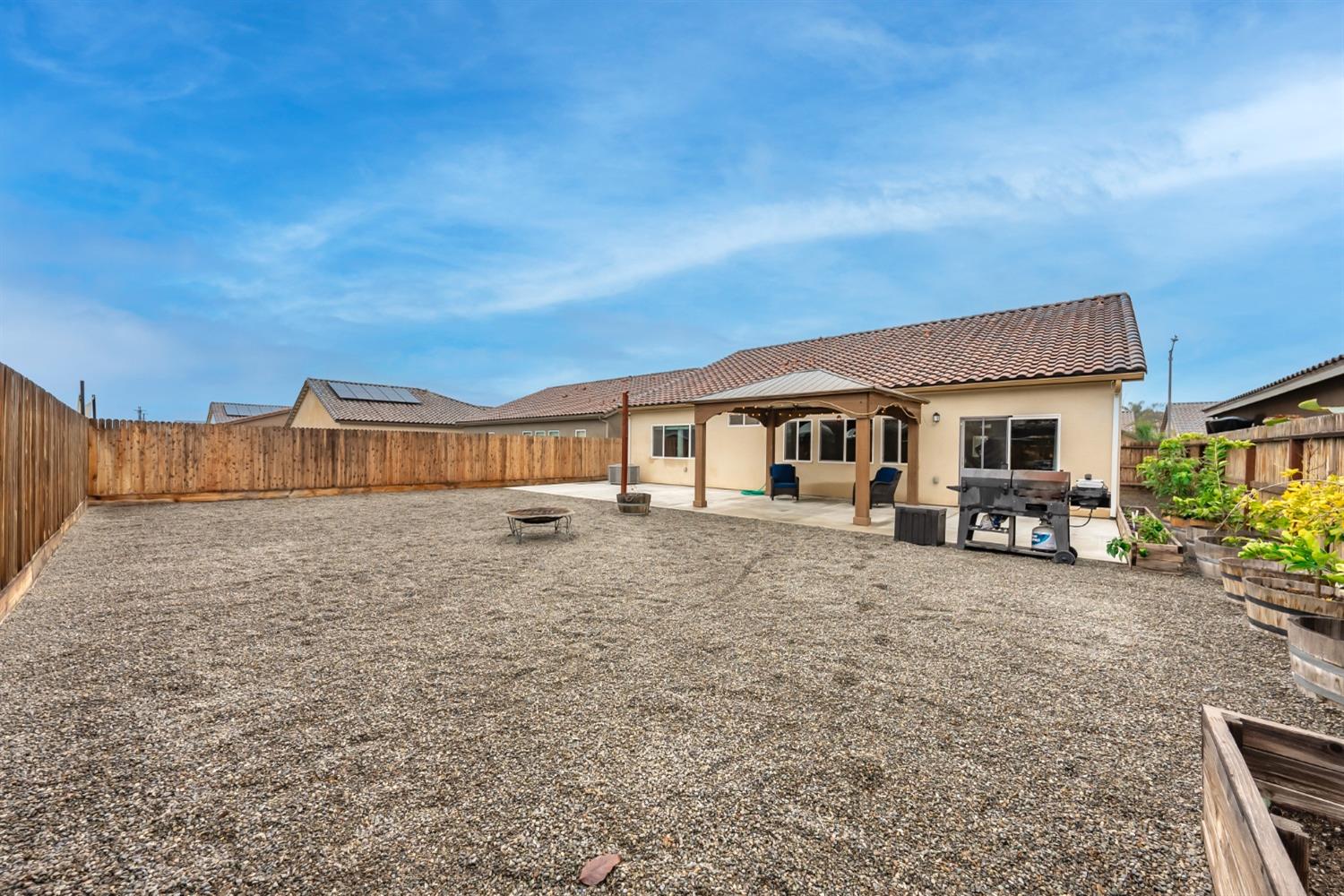 742 Strada Street Lemoore, CA 93245 - Photo 27 of 40 a view of a house with backyard and porch