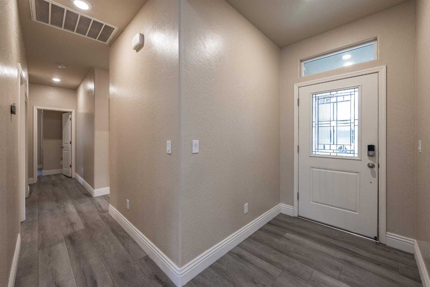 742 Strada Street Lemoore, CA 93245 - Photo 3 of 40 a view of hallway with stairs and wooden floor