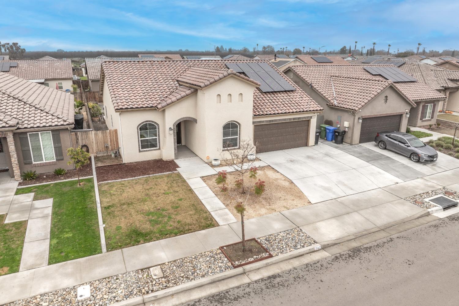742 Strada Street Lemoore, CA 93245 - Photo 35 of 40 a view of a big house with wooden fence