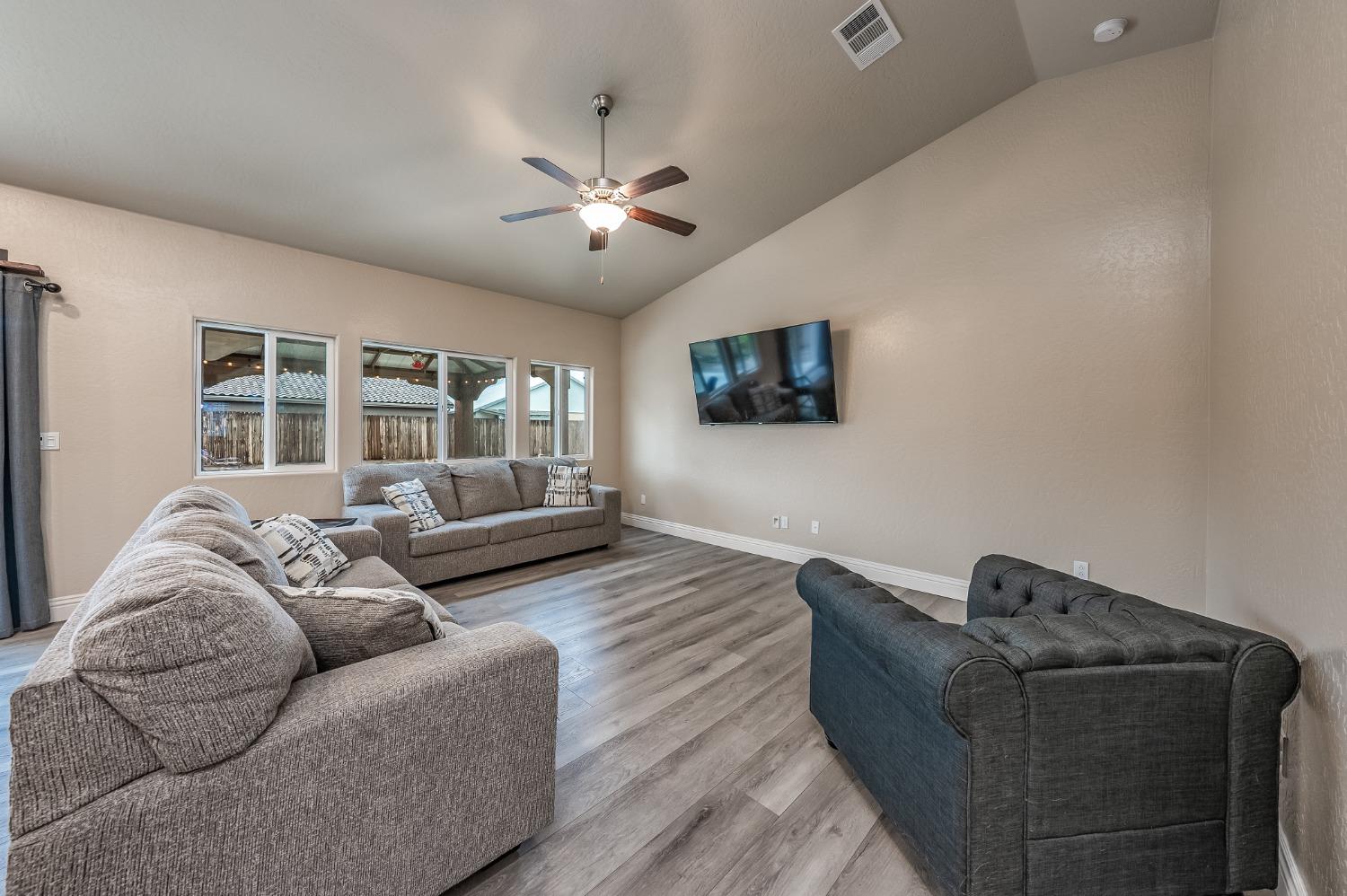 742 Strada Street Lemoore, CA 93245 - Photo 4 of 40 a living room with furniture and a flat screen tv