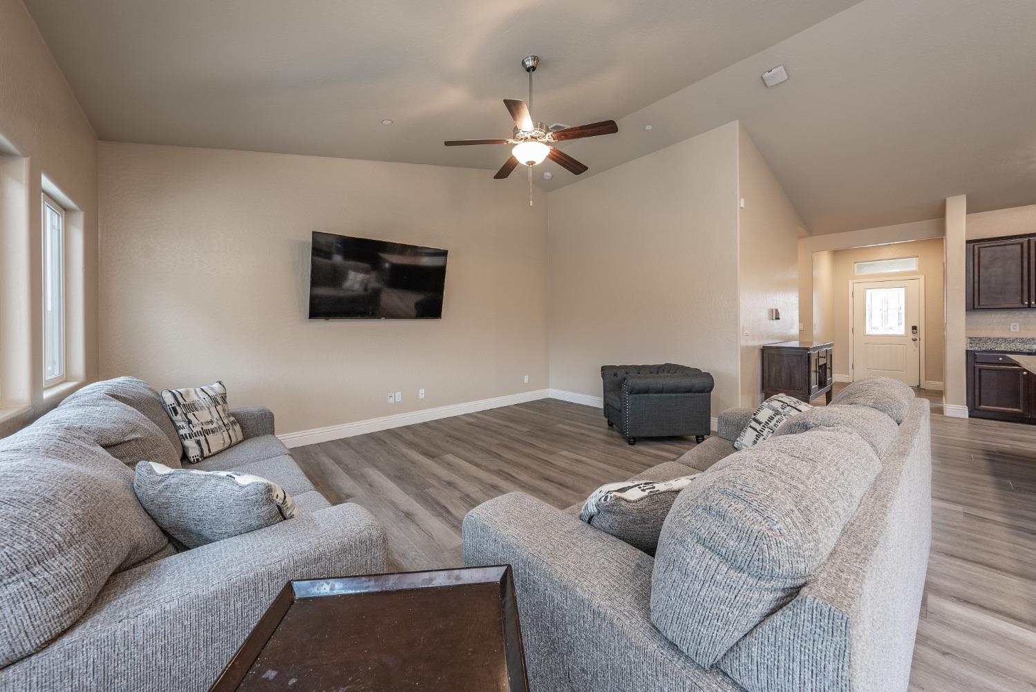 742 Strada Street Lemoore, CA 93245 - Photo 5 of 40 a living room with furniture and a flat screen tv