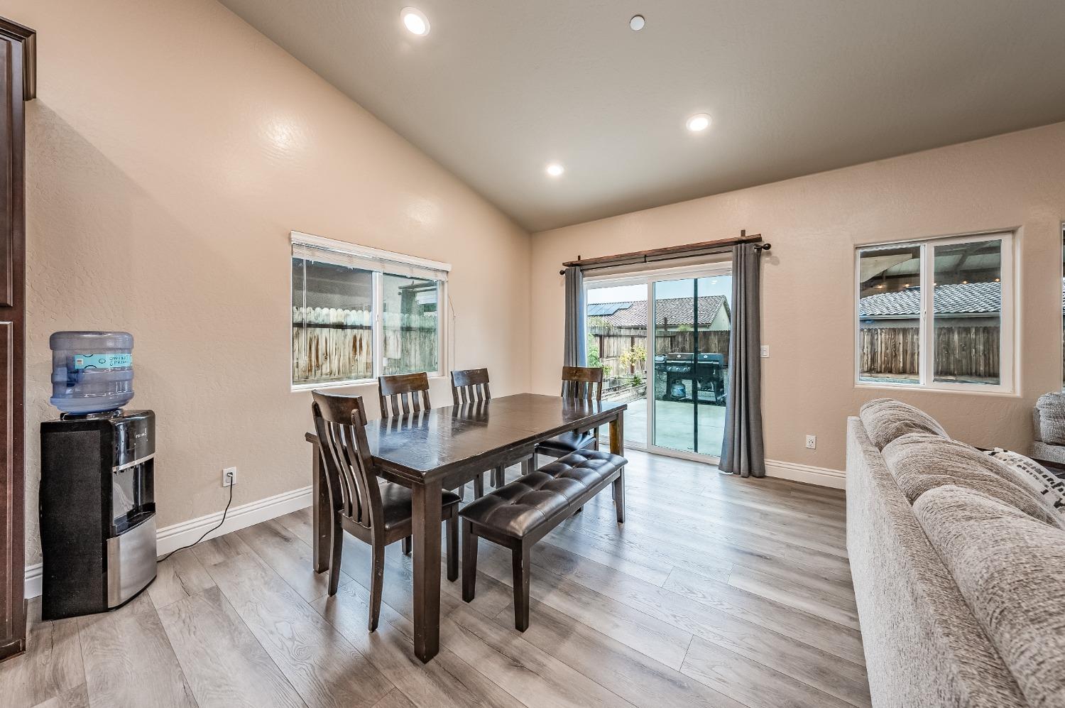 742 Strada Street Lemoore, CA 93245 - Photo 6 of 40 a view of a dining room with furniture window and wooden floor