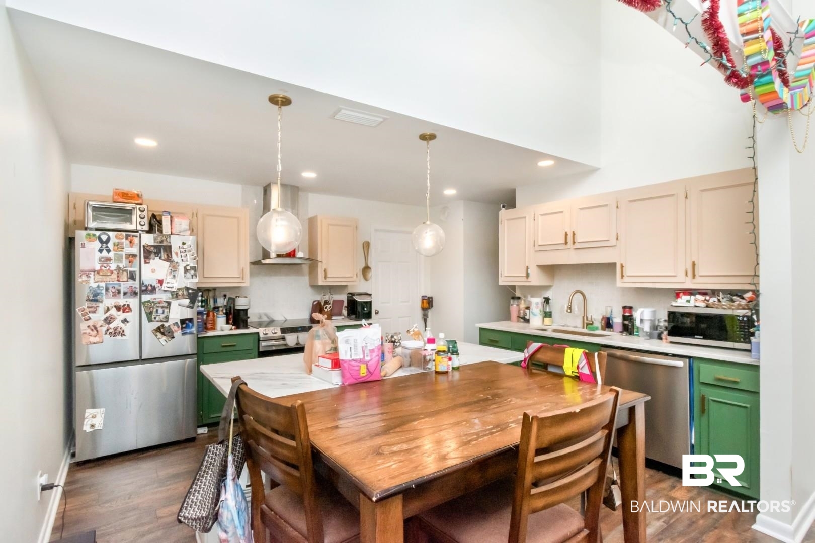 6208 Cottage Hill Road Mobile, AL 36609 - Photo 9 of 20 Kitchen featuring light countertops, stainless steel appliances, dark wood-style floors, decorative light fixtures, and two tone cabinets
