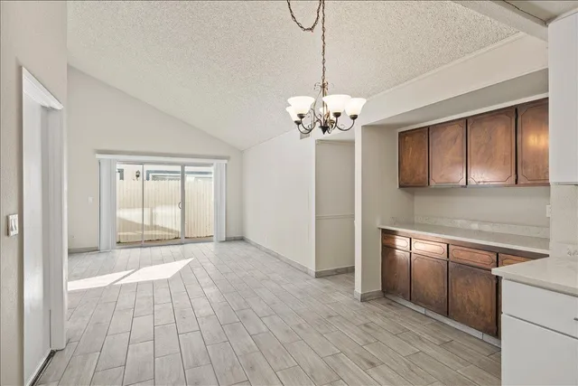 a view of a kitchen with wooden floor and a kitchen