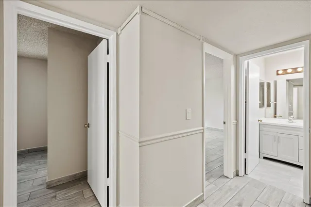 a view of a hallway with wooden floor