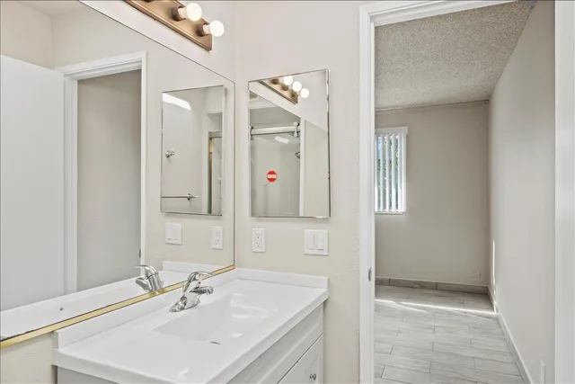 a bathroom with a sink vanity and mirror