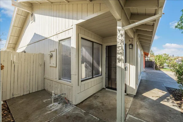 a view of an empty room with closet and a window