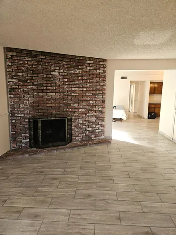 a view of empty room with a fireplace