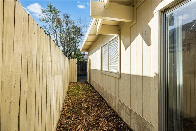 a view of a yard with wooden fence