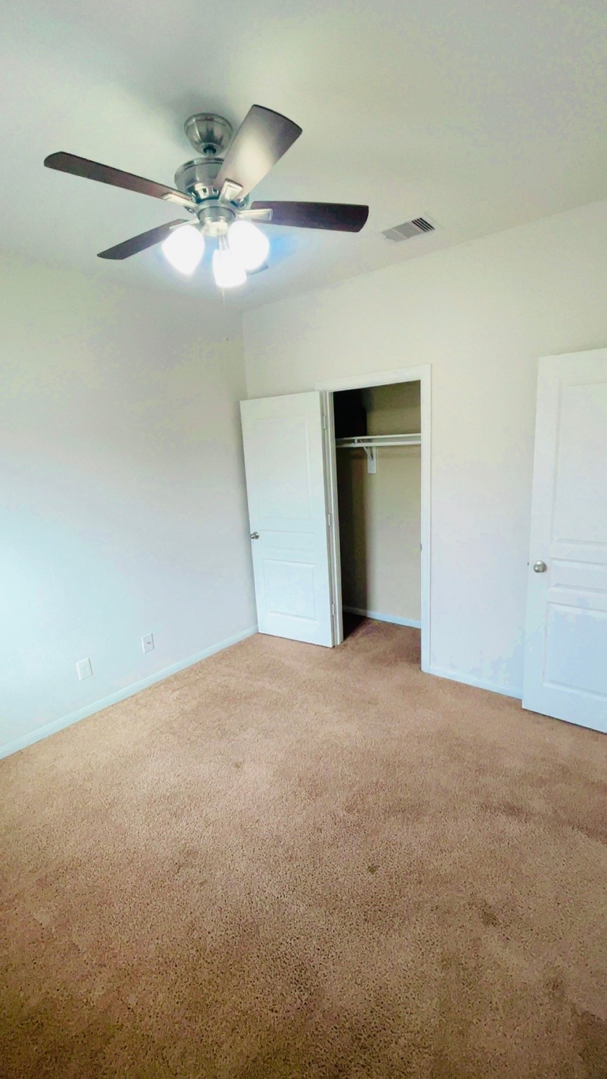 8626 Willet Street Baytown, TX 77521 - Photo 12 of 37 a view of an empty room with a chandelier fan