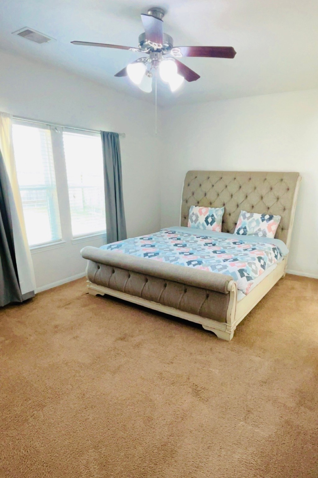 8626 Willet Street Baytown, TX 77521 - Photo 20 of 37 a bedroom with a bed chandelier and a window