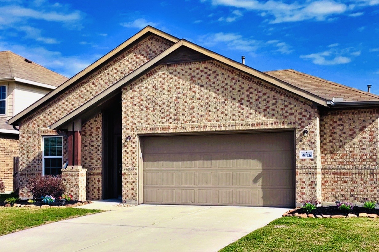 8626 Willet Street Baytown, TX 77521 - Photo 2 of 37 a front view of a house with a garden