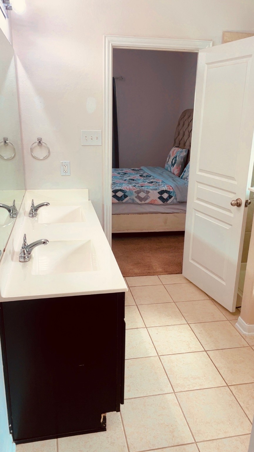 8626 Willet Street Baytown, TX 77521 - Photo 22 of 37 a bedroom with a bed and a mirror in it