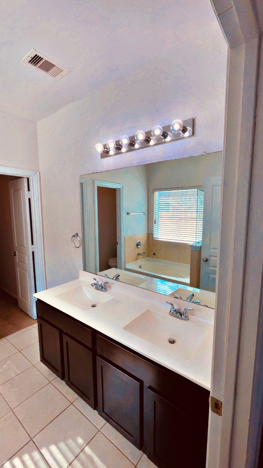 8626 Willet Street Baytown, TX 77521 - Photo 24 of 37 a bathroom with a sink vanity and mirror