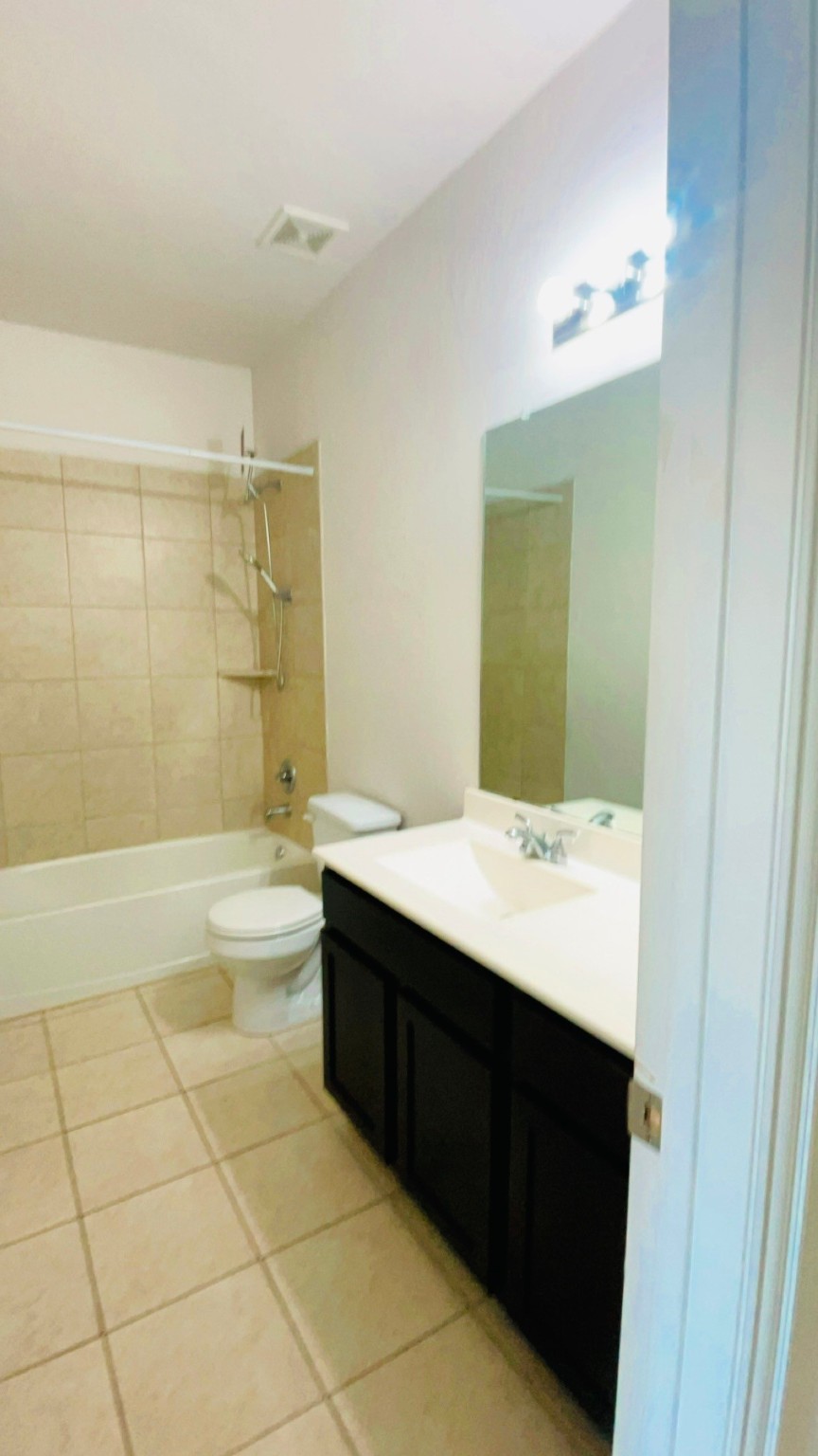 8626 Willet Street Baytown, TX 77521 - Photo 10 of 37 a bathroom with a bathtub a sink and a shower