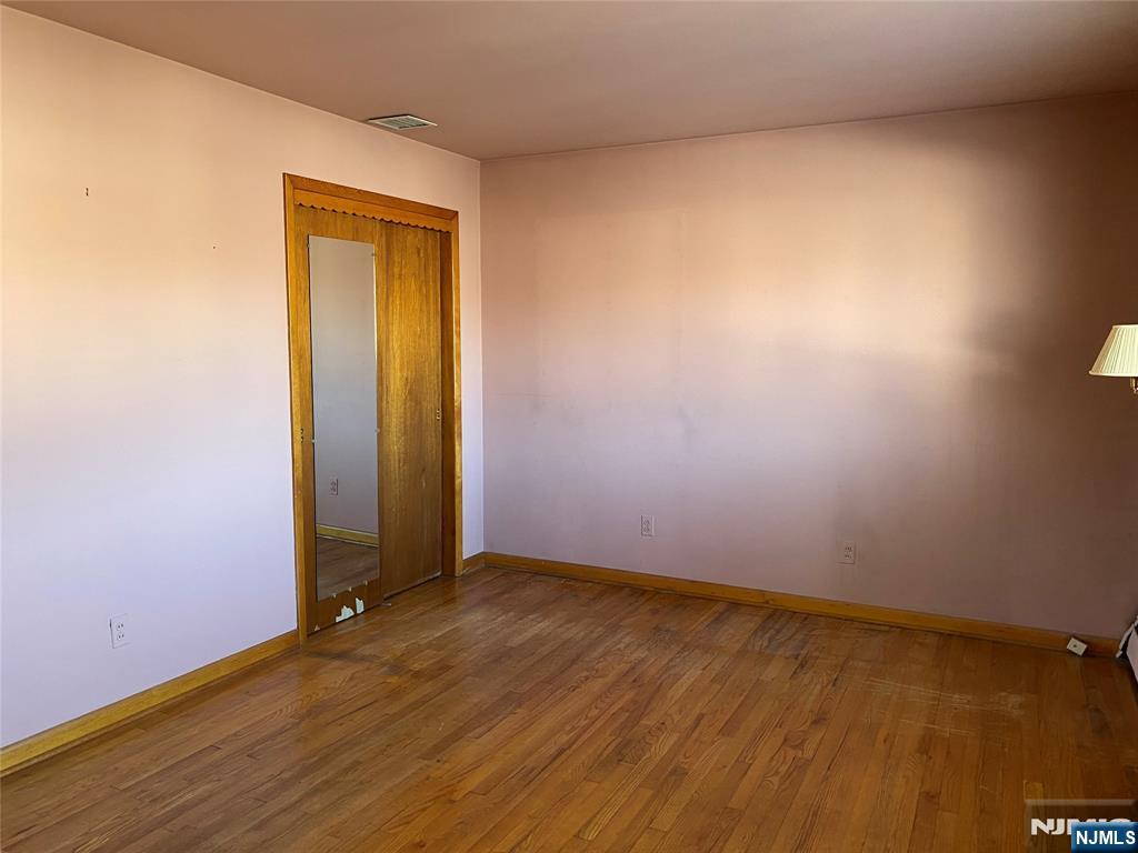 95 Atkins Terrace East Rutherford, NJ 07073 - Photo 11 of 31 an empty room with wooden floor and closet