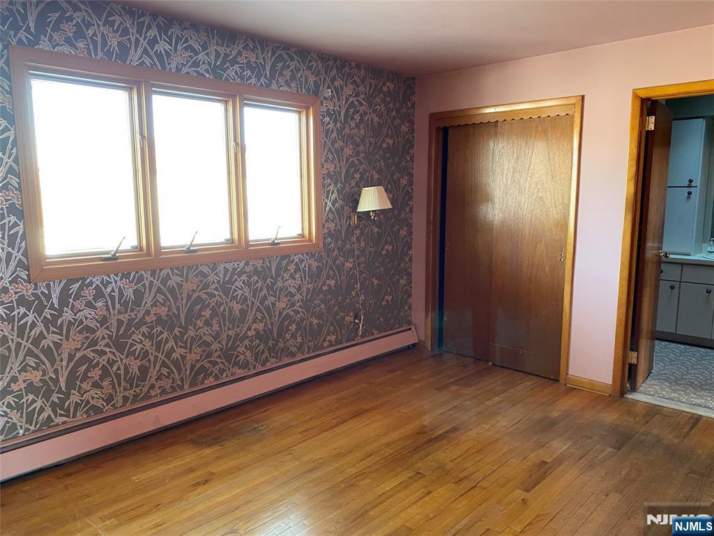 95 Atkins Terrace East Rutherford, NJ 07073 - Photo 12 of 31 a view of an empty room with wooden floor and a window
