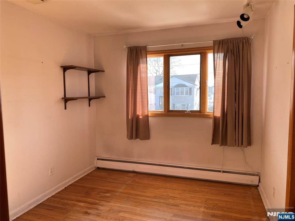 95 Atkins Terrace East Rutherford, NJ 07073 - Photo 15 of 31 an empty room with wooden floor and windows