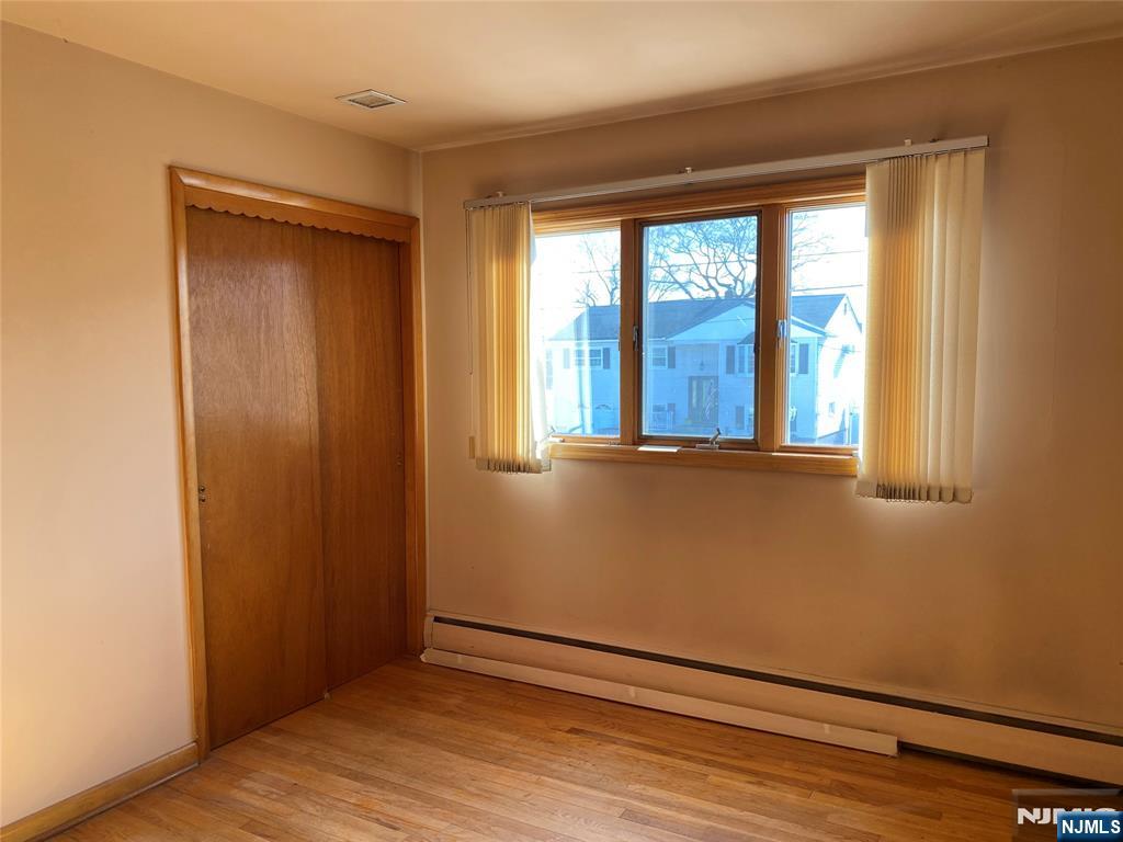 95 Atkins Terrace East Rutherford, NJ 07073 - Photo 18 of 31 an empty room with wooden floor and windows
