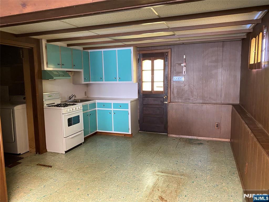 95 Atkins Terrace East Rutherford, NJ 07073 - Photo 27 of 31 a kitchen with white cabinets and white appliances