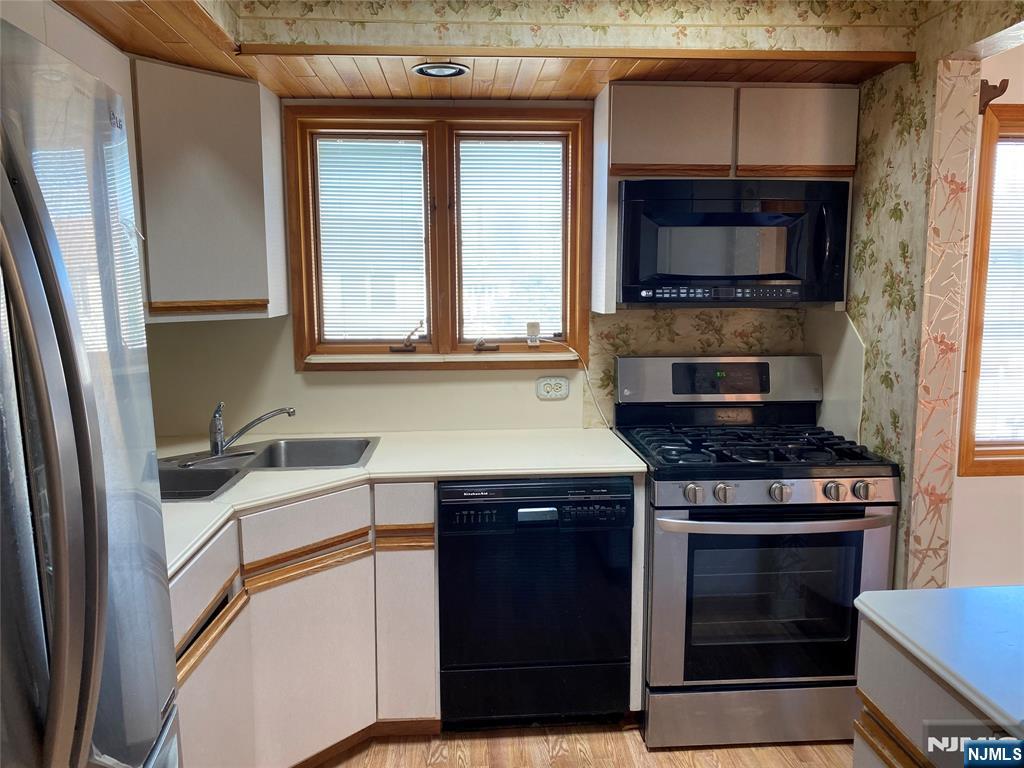 95 Atkins Terrace East Rutherford, NJ 07073 - Photo 8 of 31 a kitchen with a stove and a microwave