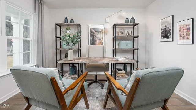 a view of a livingroom with furniture wooden floor and windows