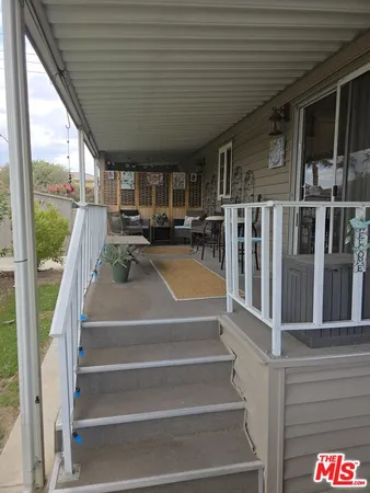 a outdoor living space with furniture and a rug