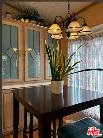 a kitchen with a stove and a wooden floor