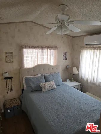 a bedroom with a bed and cabinets