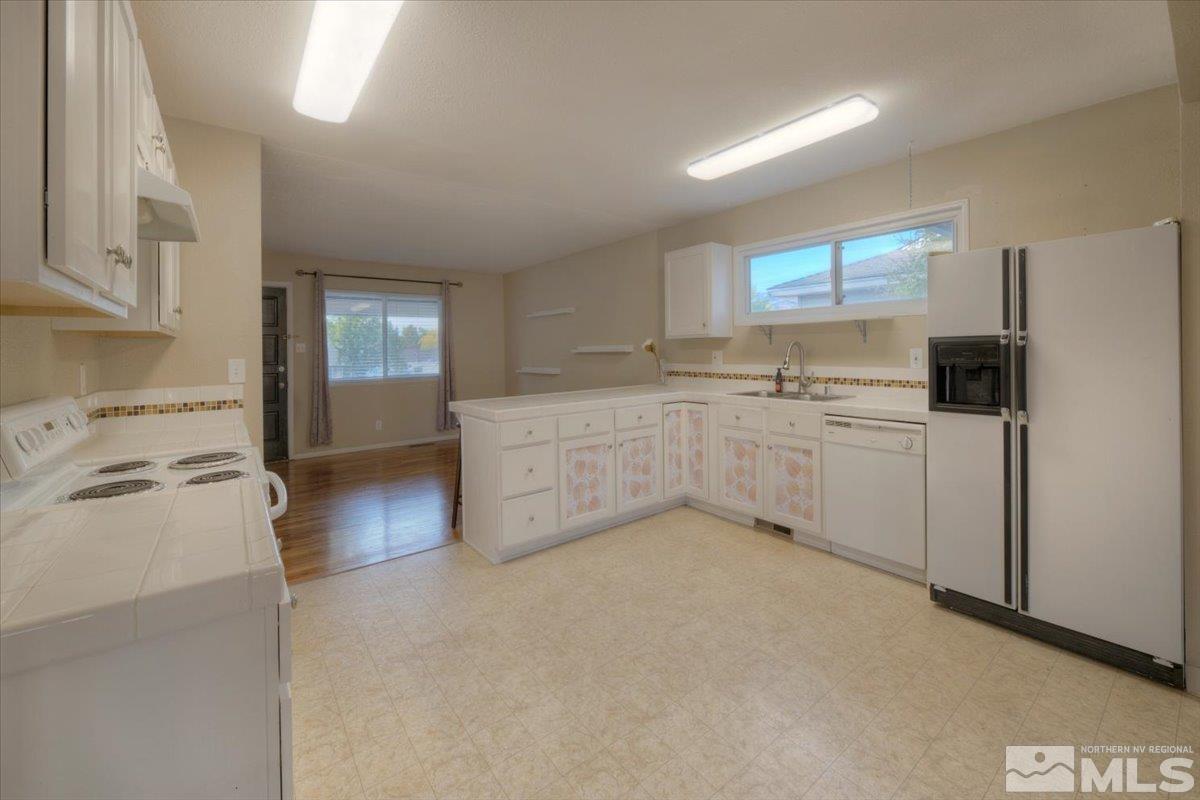 3451 Rauscher Drive Reno, NV 89503 - Photo 14 of 29 a kitchen with a sink a stove and cabinets