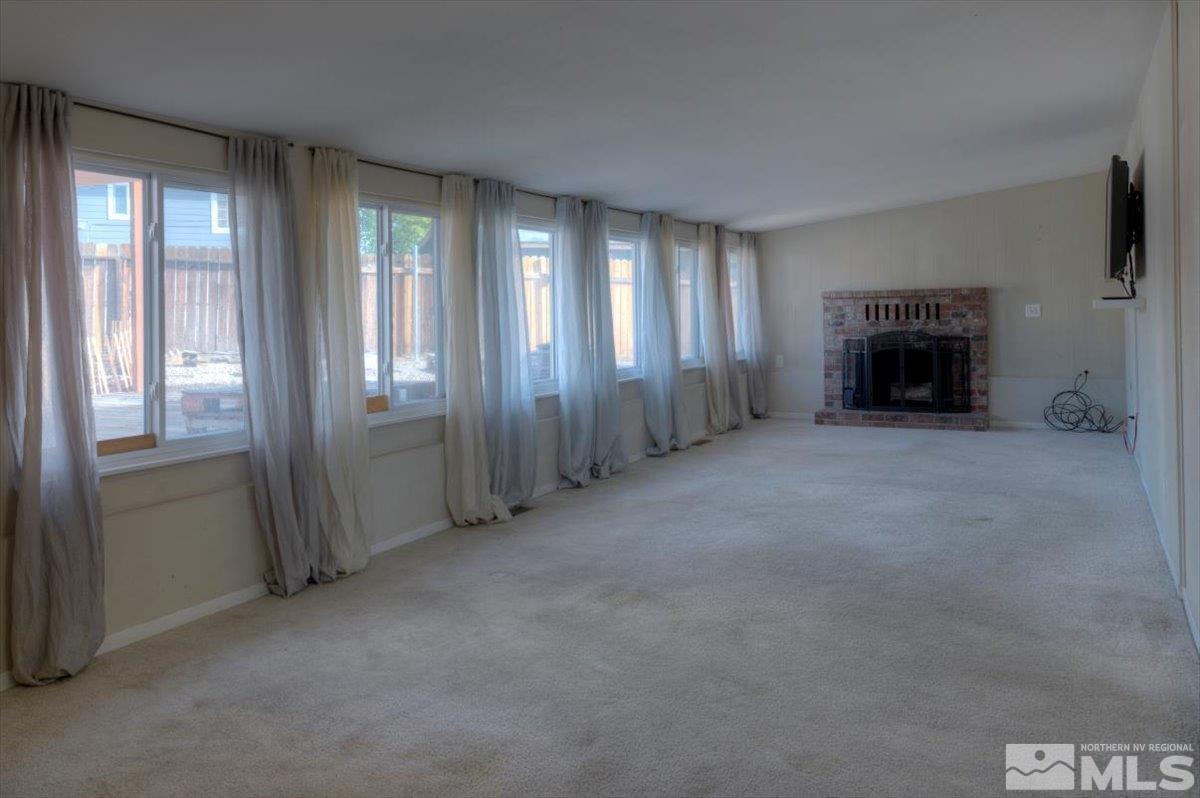 3451 Rauscher Drive Reno, NV 89503 - Photo 17 of 29 an empty room with windows and fireplace