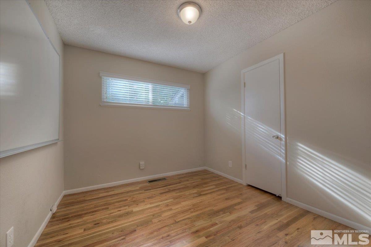 3451 Rauscher Drive Reno, NV 89503 - Photo 21 of 29 a view of empty room with wooden floor and fan