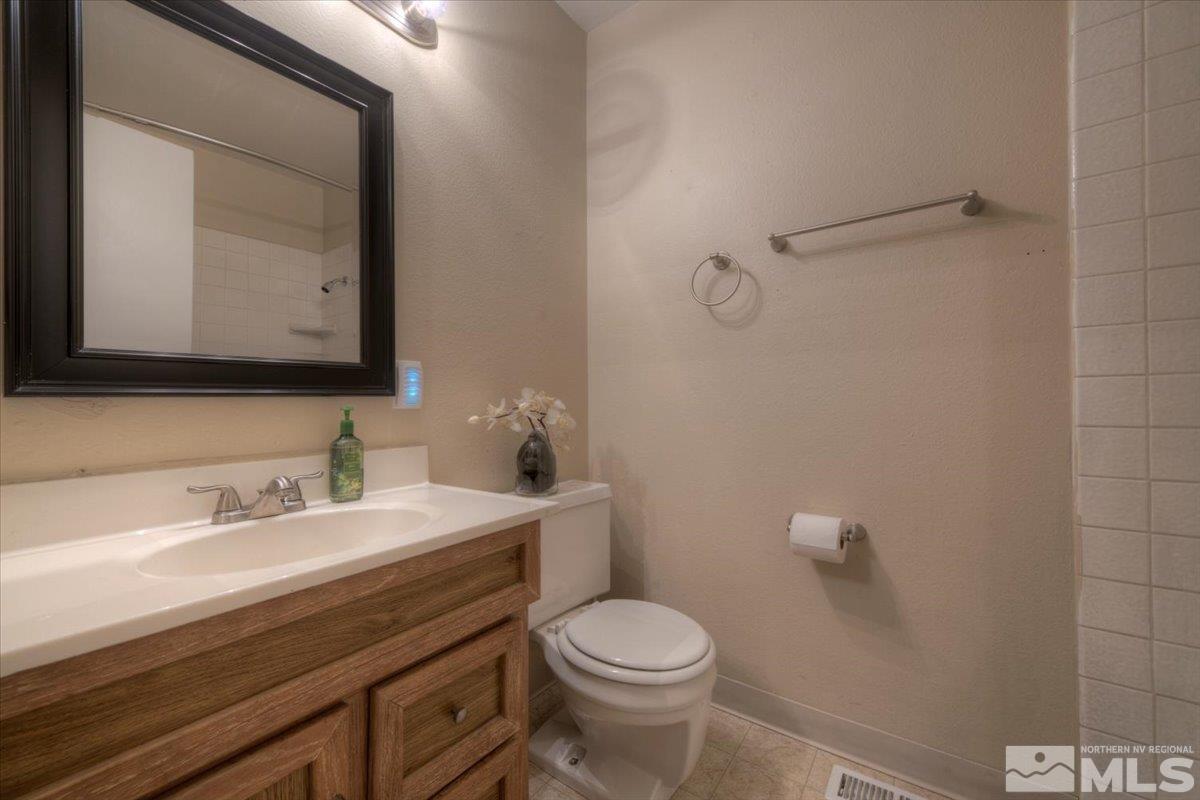 3451 Rauscher Drive Reno, NV 89503 - Photo 22 of 29 a bathroom with a sink a toilet and mirror
