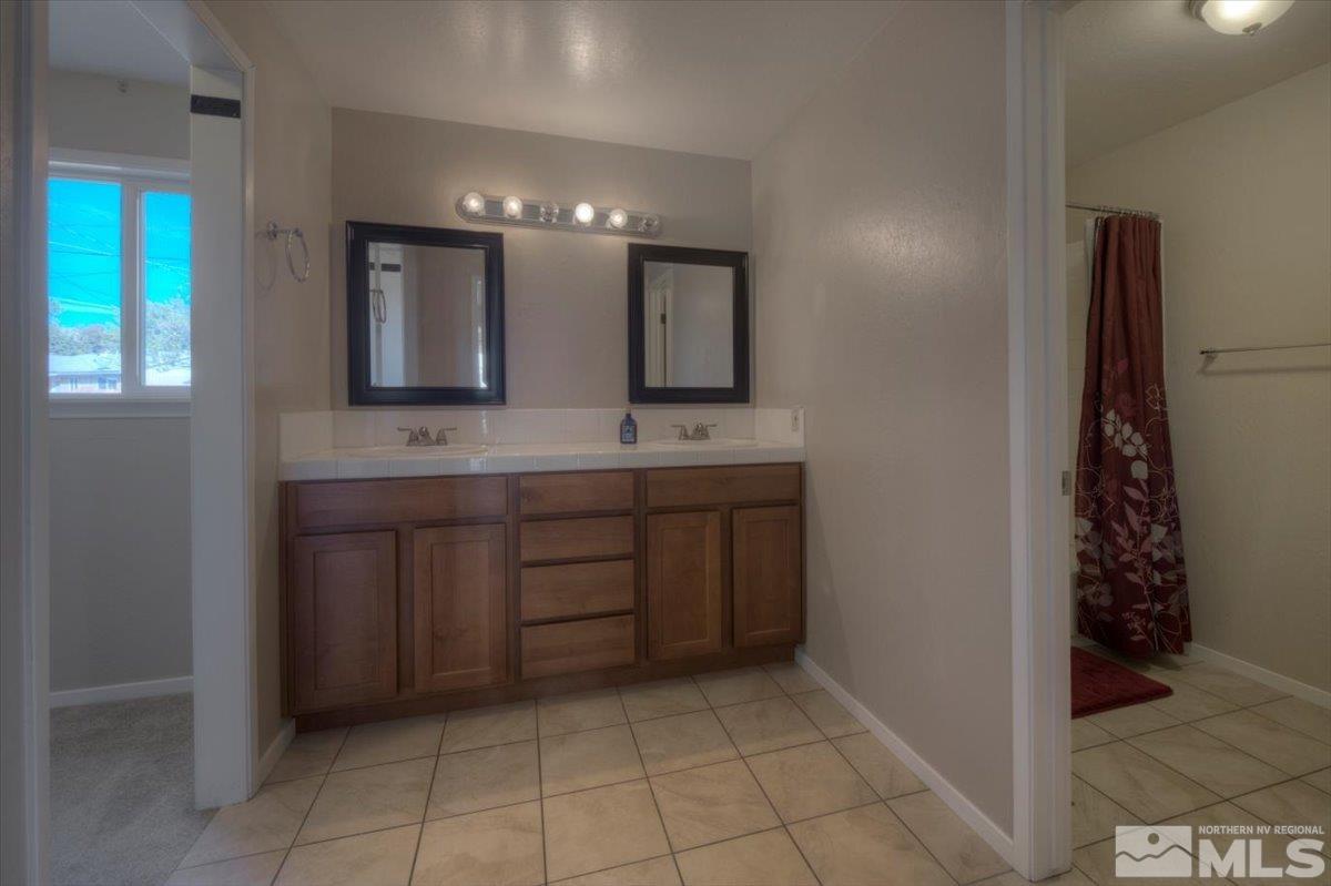 3451 Rauscher Drive Reno, NV 89503 - Photo 26 of 29 a bathroom with a sink a vanity and a mirror
