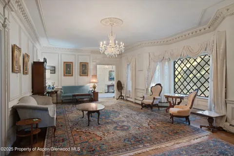 a living room with furniture and a chandelier