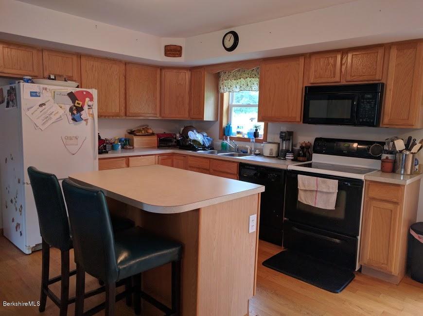 13 A Glendale Middle Road Stockbridge, MA 01262 - Photo 2 of 11 a kitchen with stainless steel appliances a stove a sink dishwasher and a refrigerator