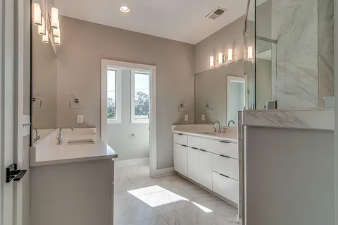 a bathroom with a double vanity sink mirror and double