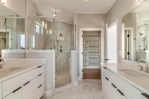 a bathroom with a shower sink vanity and mirror