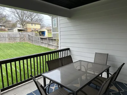 a view of a patio with table and chairs