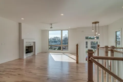 a view of a living room and kitchen with furniture fireplace and wooden floor