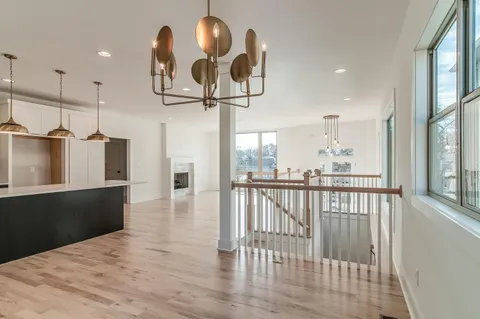 a view of a living room and dining room with wooden floor