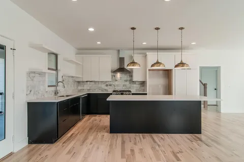 a kitchen with kitchen island sink stove and refrigerator