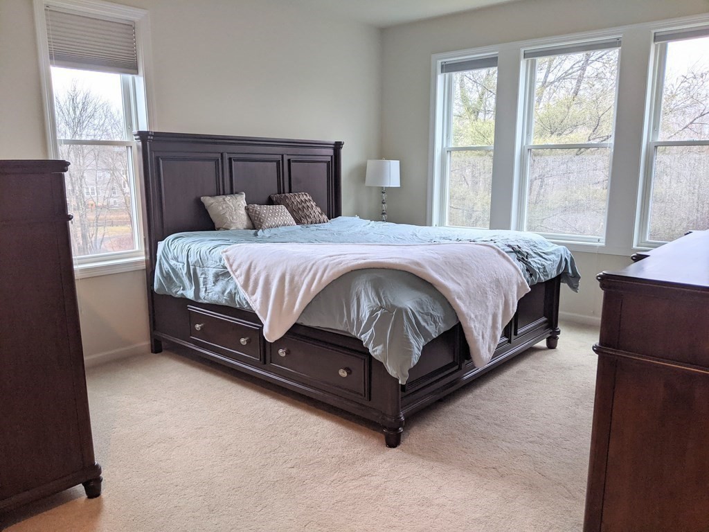 70 Trotter Road, Unit 312 Weymouth, MA 02190 - Photo 13 of 18 a spacious bedroom with a bed and window