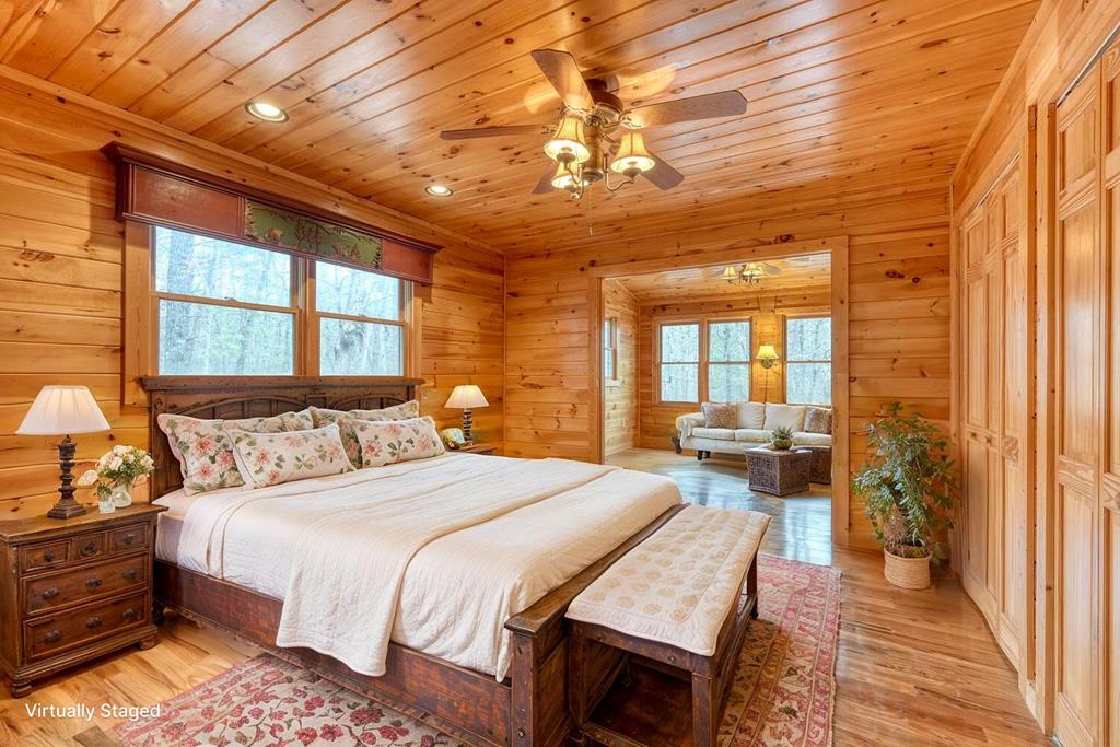 180 Shepherds Ridge Morganton, GA 30560 - Photo 3 of 66 a bedroom with a bed a chandelier and large window